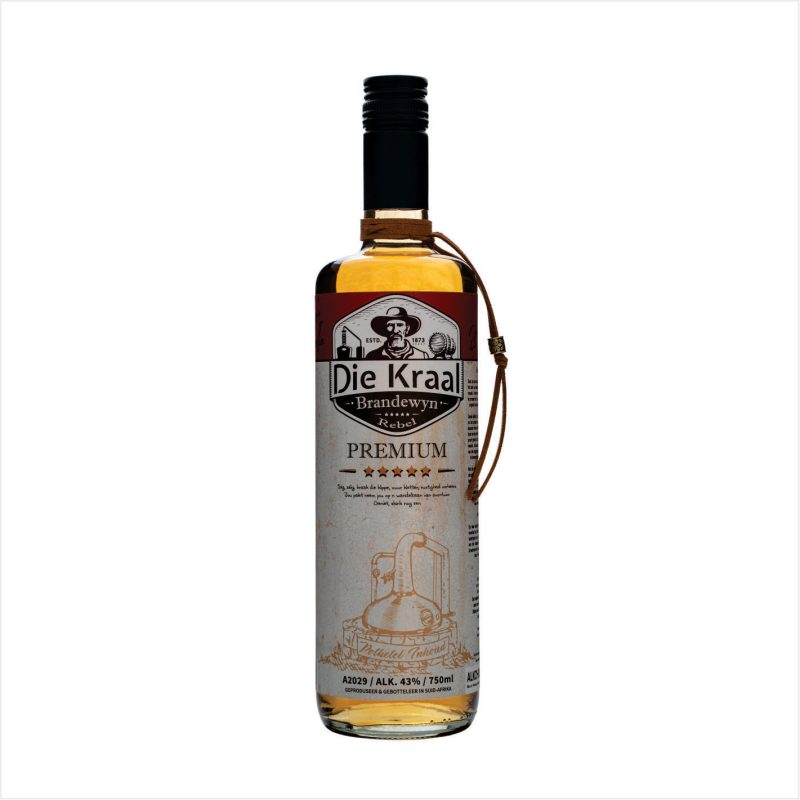 A bottle of Die Kraal Brandewyn Rebel Premium with a clear liquid inside, featuring an intricate label with a copper pot still illustration, product details, and a leather strap around the neck of the bottle.